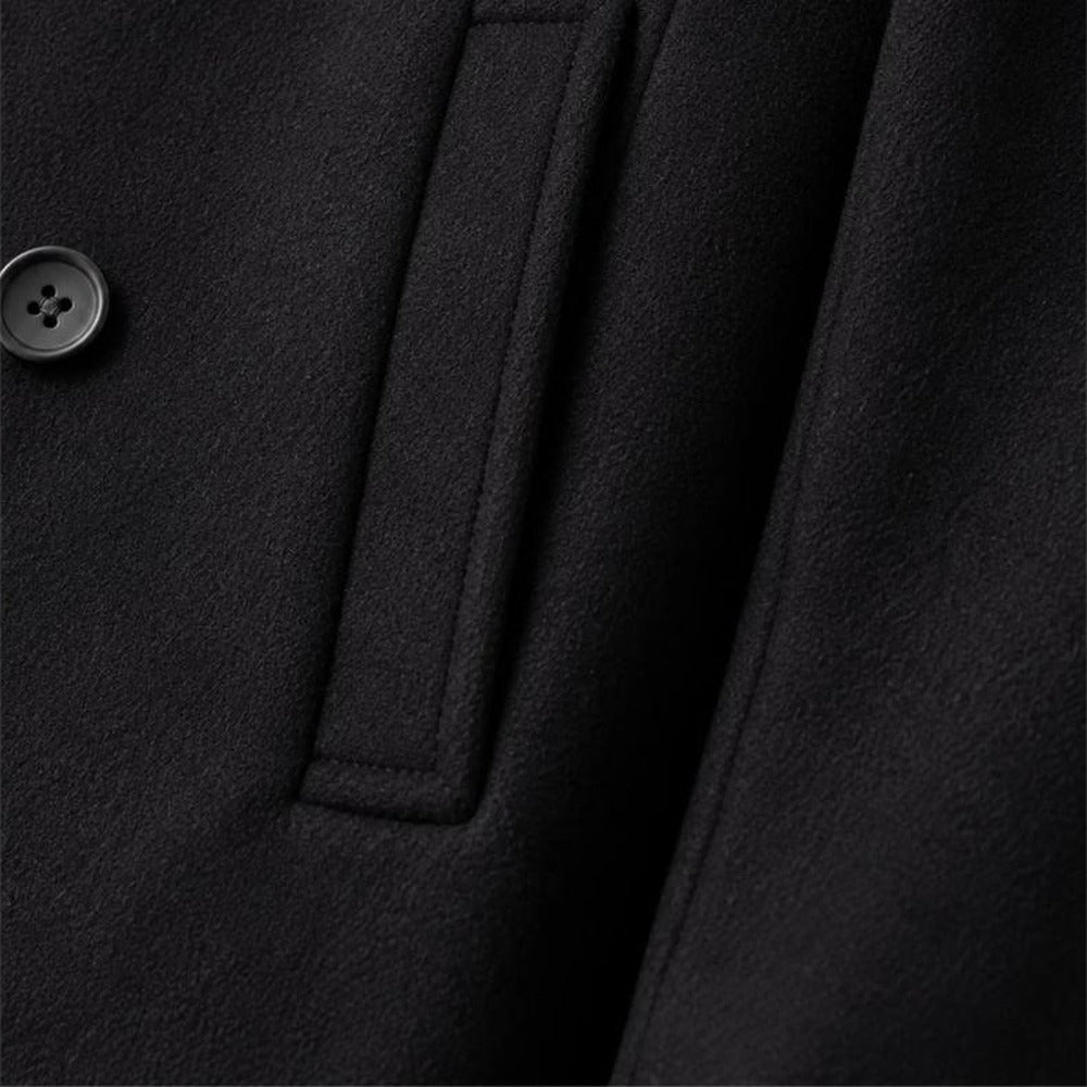 Close-up of black peacoat side pocket and fabric detail