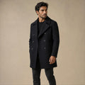 Man wearing black wool blend double-breasted peacoat, lifestyle photo